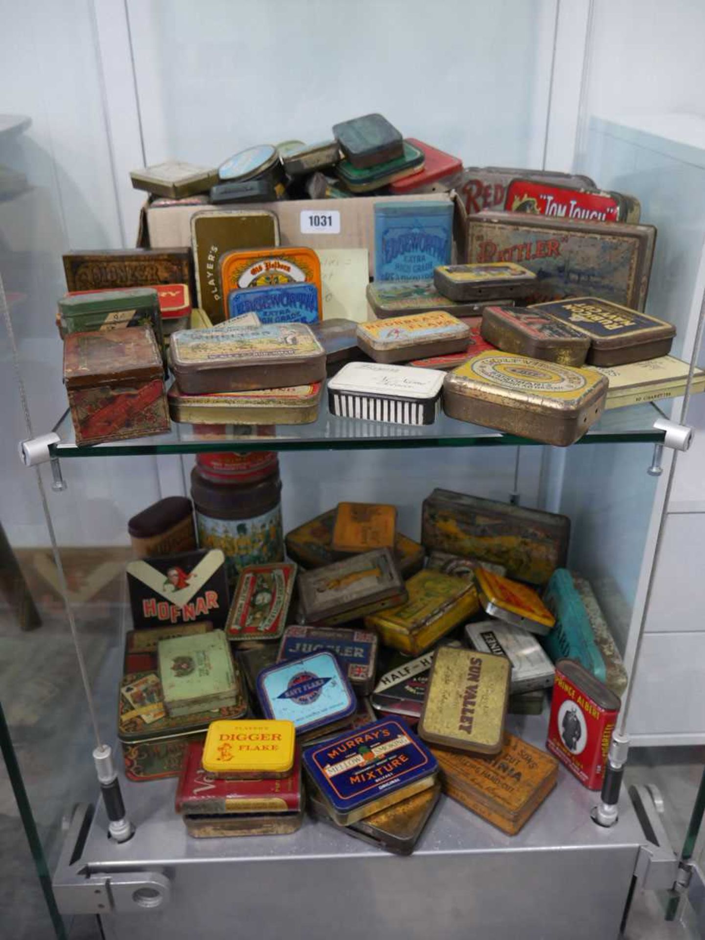 2 shelves of collectible tins, mostly tobacco