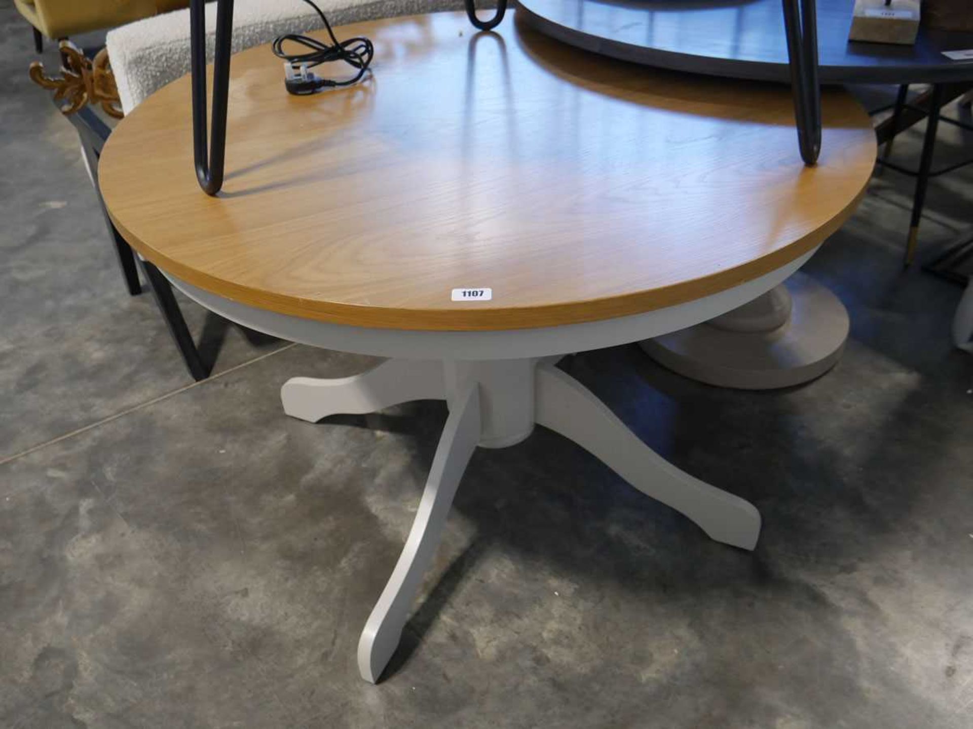 White single pedestal dining table with circular light oak surface