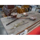 Collection of copper and brassware including long brass fire tongs, poker, 2 bed warming pans and