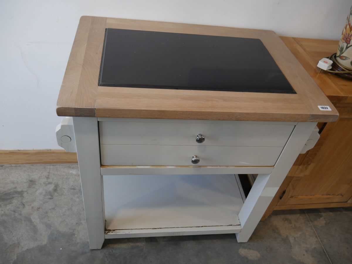 Modern light grey kitchen island with granite chopping surface and large single drawer