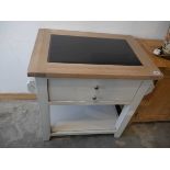 Modern light grey kitchen island with granite chopping surface and large single drawer