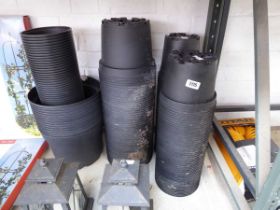 Large quantity of various sized black plastic garden pots