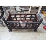 Black decorative fire grate with acorn shaped finials