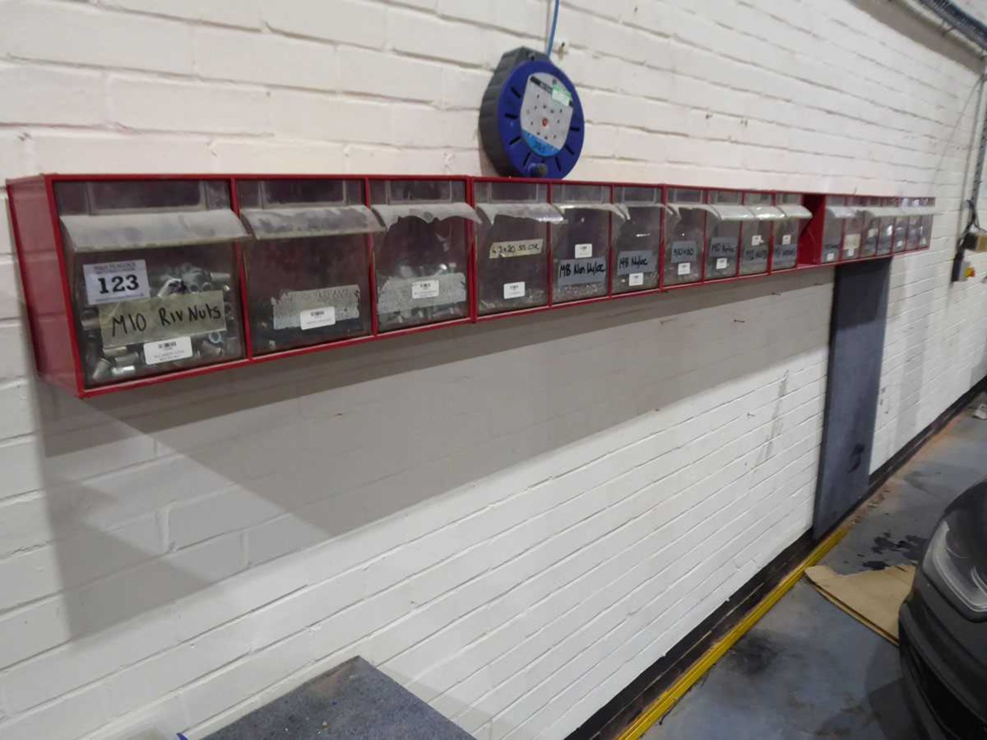 +VAT Red wall mounted nut and bolt rack with contents together with 2 linbin racks and sundry