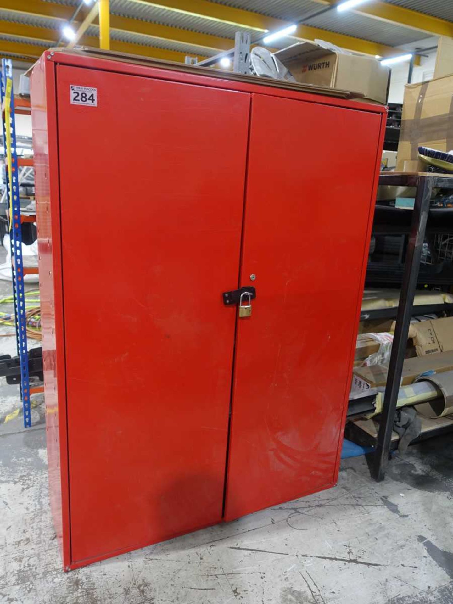 +VAT Red steel double door cupboard, containing miscellaneous contents