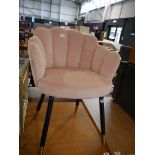 Pink suede upholstered shell shaped dining chair on black tapered supports