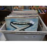 Crate containing a quantity of records to include Tubular Bells, The Moody Blues, Elvis, Status Quo,