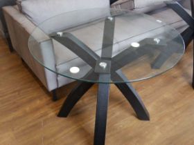Circular glass dining table on black ash crisscross base