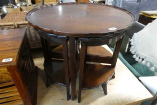 Mahogany occasional table with pie crust border and 4 small nesting tables below