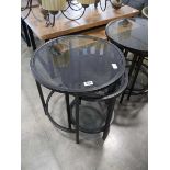 Nesting pair of black metal framed circular occasional tables with glass surfaces