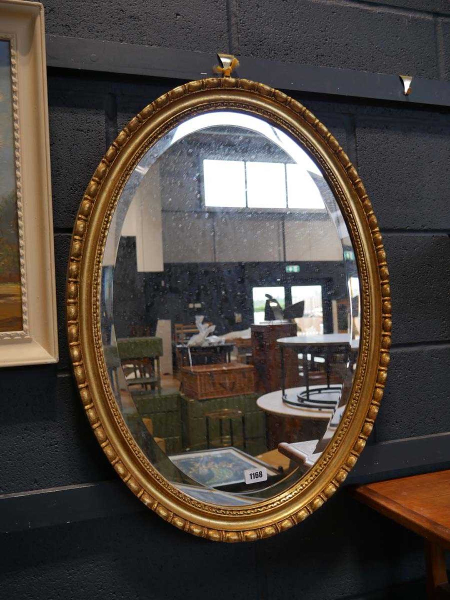 Gilt framed and bevelled oval wall mirror