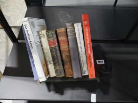 Small dark oak bookstand with contents of various books on various themes