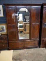 Edwardian mahogany wardrobe with bevelled mirrored central door and single drawer to base