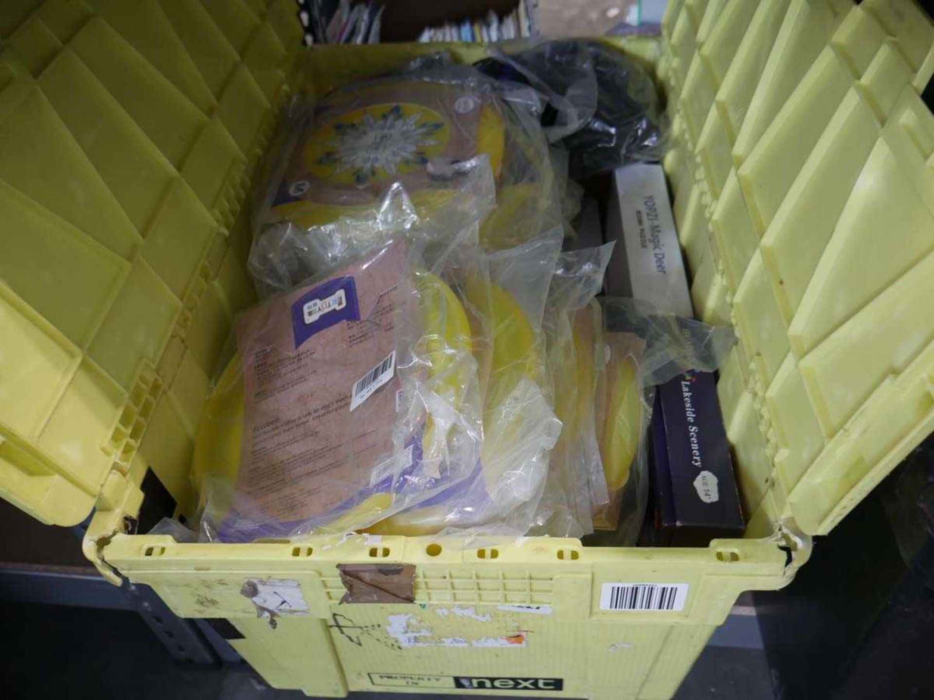 Crate containing a large quantity of frisbees, jigsaws, etc.