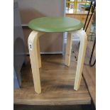 Small circular green stool on beech coloured legs