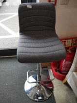 Grey upholstered bar stool on chrome support