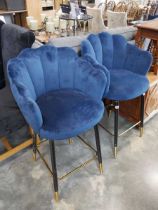 Modern pair of blue upholstered bar height stools on black supports