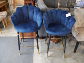 Modern pair of blue upholstered bar height stools on black supports