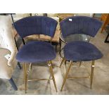 Modern pair of navy suede upholstered bar height stools on brass effect supports