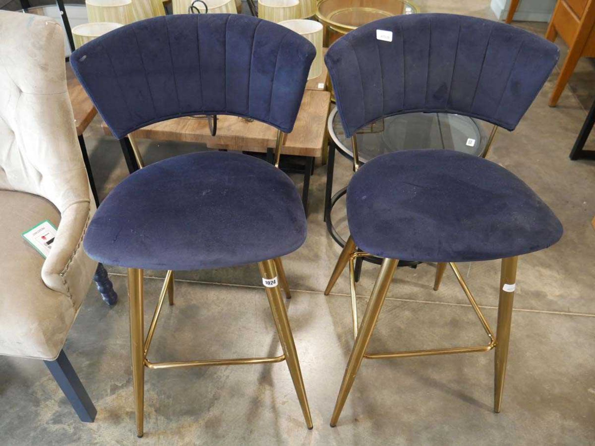 Modern pair of navy suede upholstered bar height stools on brass effect supports