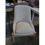 Wooden framed easy chair upholstered in a natural finish