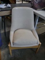 Wooden framed easy chair upholstered in a natural finish