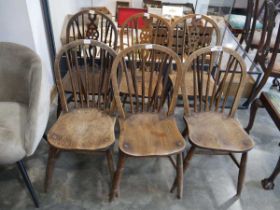 Set of 3 similar dark oak wheel back dining chairs and 3 further spindle back dining chairs