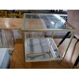 Small glass top side table in brass finish with mirrored lower shelf