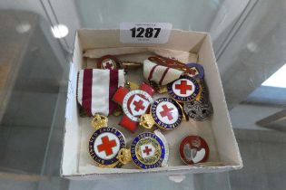 Small box containing quantity of British Red Cross Society badges