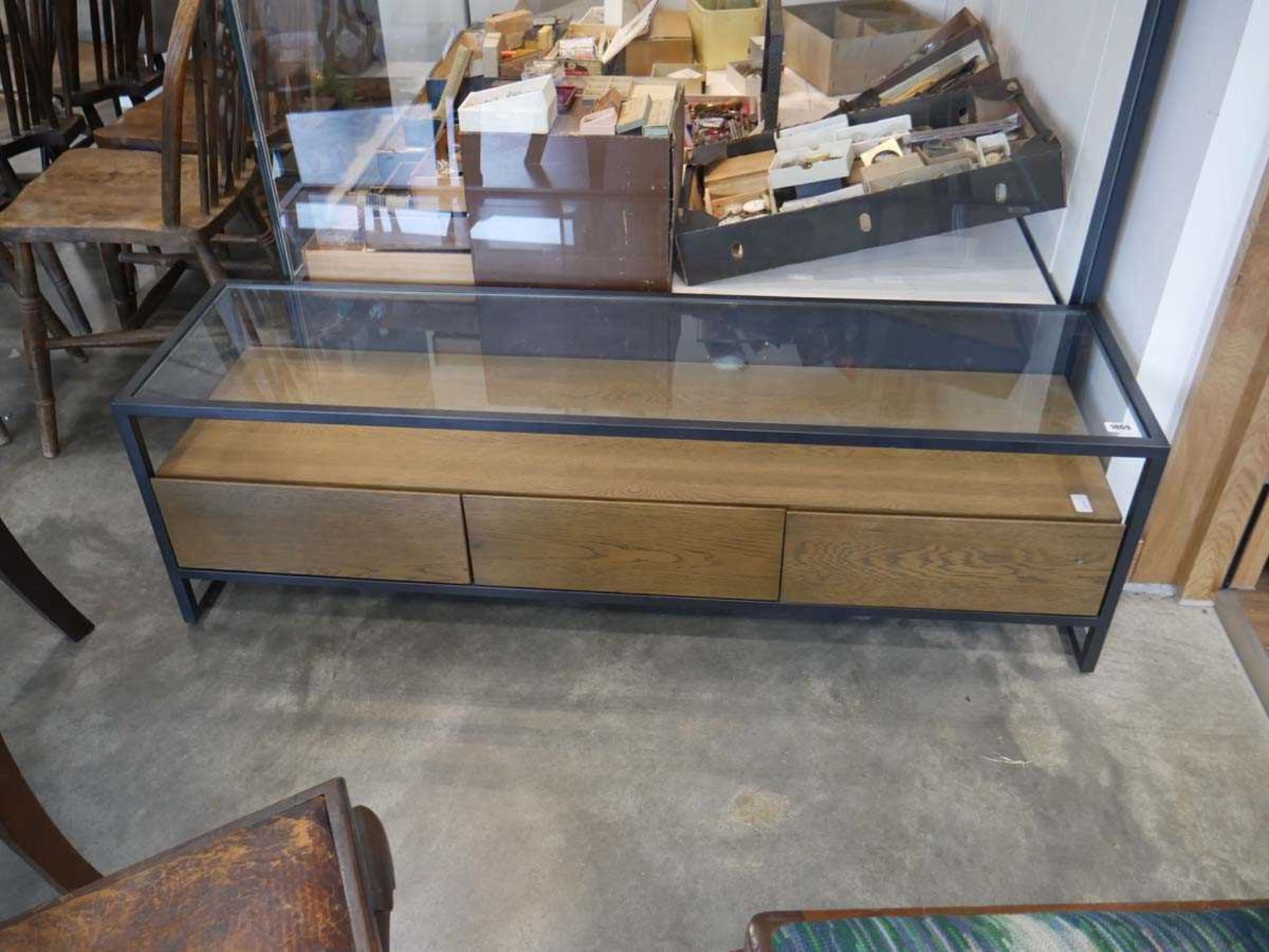 Metal framed entertainment stand with glass surface and 3 hardwood finish drawers below