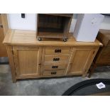 Modern light oak sideboard with 4 central drawers and 2 cupboards Some water damage to side Some