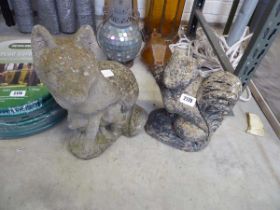 2 concrete animal statues in the form of a squirrel and a fox