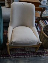 Wooden framed easy chair upholstered in a natural finish