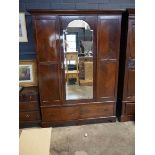 Edwardian mahogany wardrobe with bevelled mirrored central door and single drawer to base