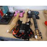 3 various childrens electric guitars, 1 pink, 1 black with flame effect and 1 black with star