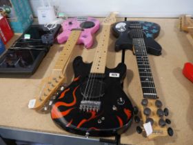 3 various childrens electric guitars, 1 pink, 1 black with flame effect and 1 black with star
