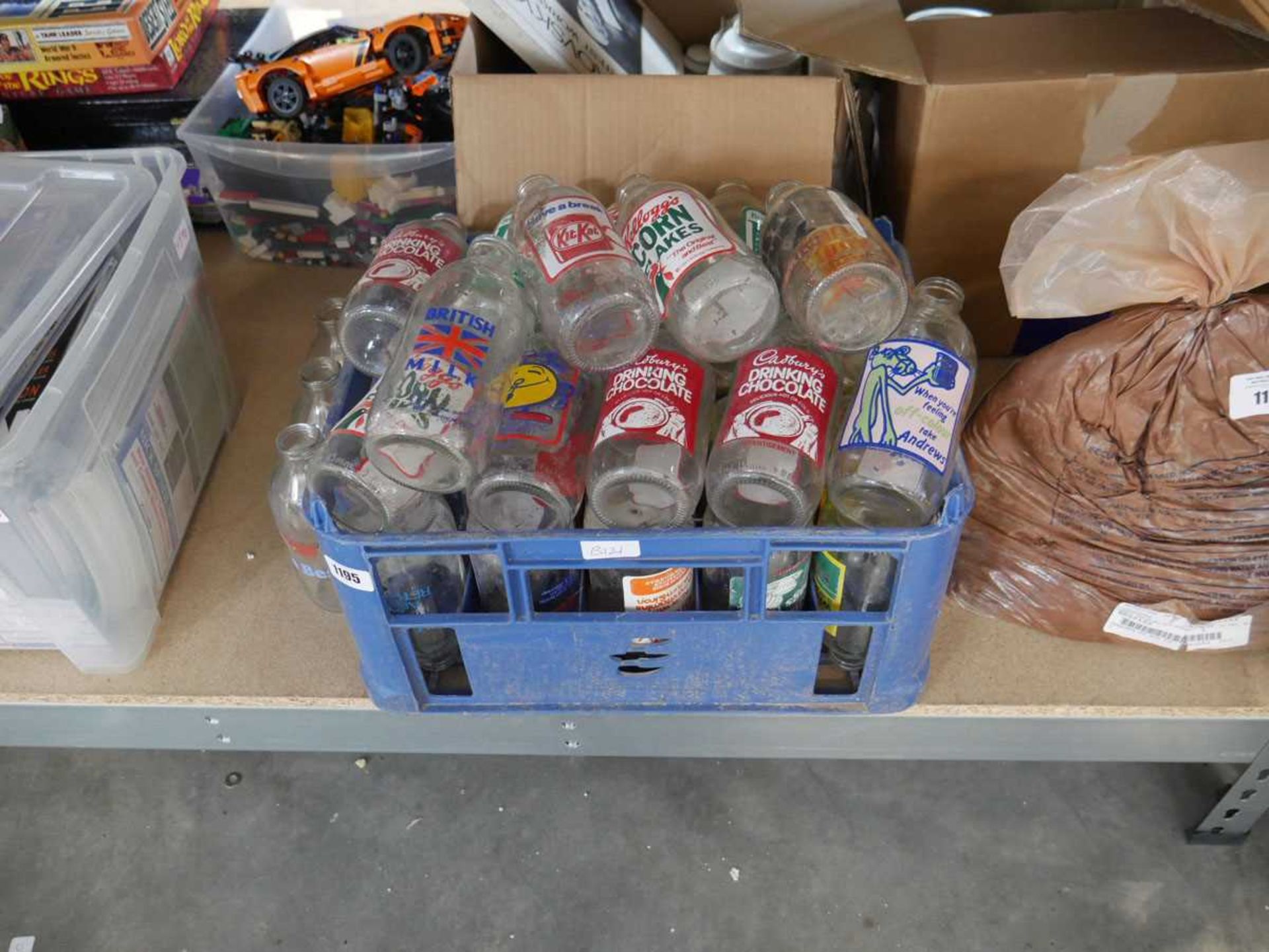 Crate containing a selection of vintage collectible milk bottles to include cornflakes, Kit Kat,