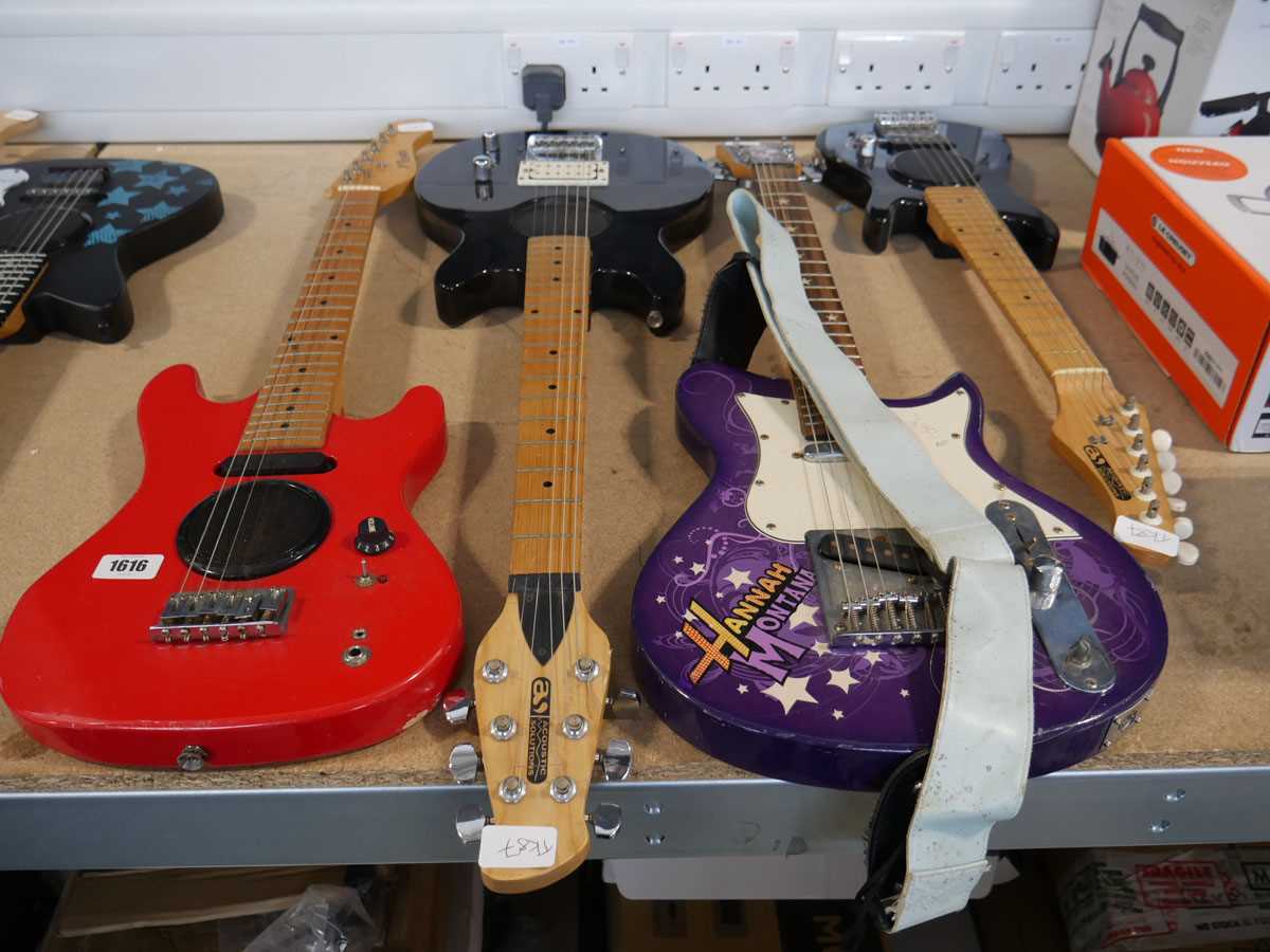 4 various childrens electric guitars; 1 Hannah Montanna, 2 black with built in speakers and 1 red