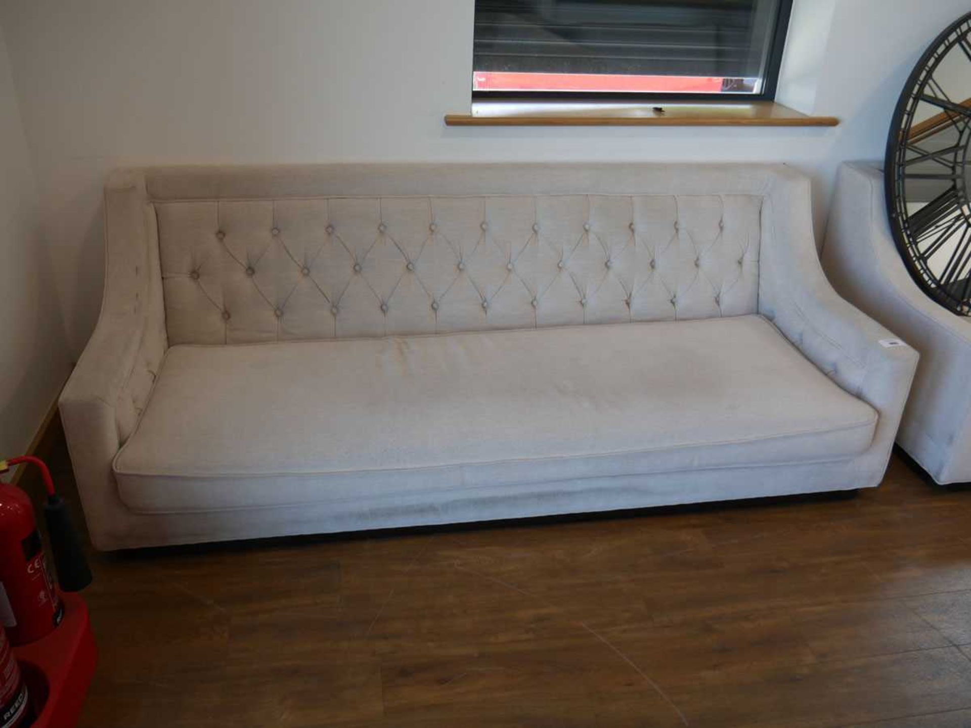 +VAT Low level beige upholstered button back sofa on black plinth type base - Image 2 of 2