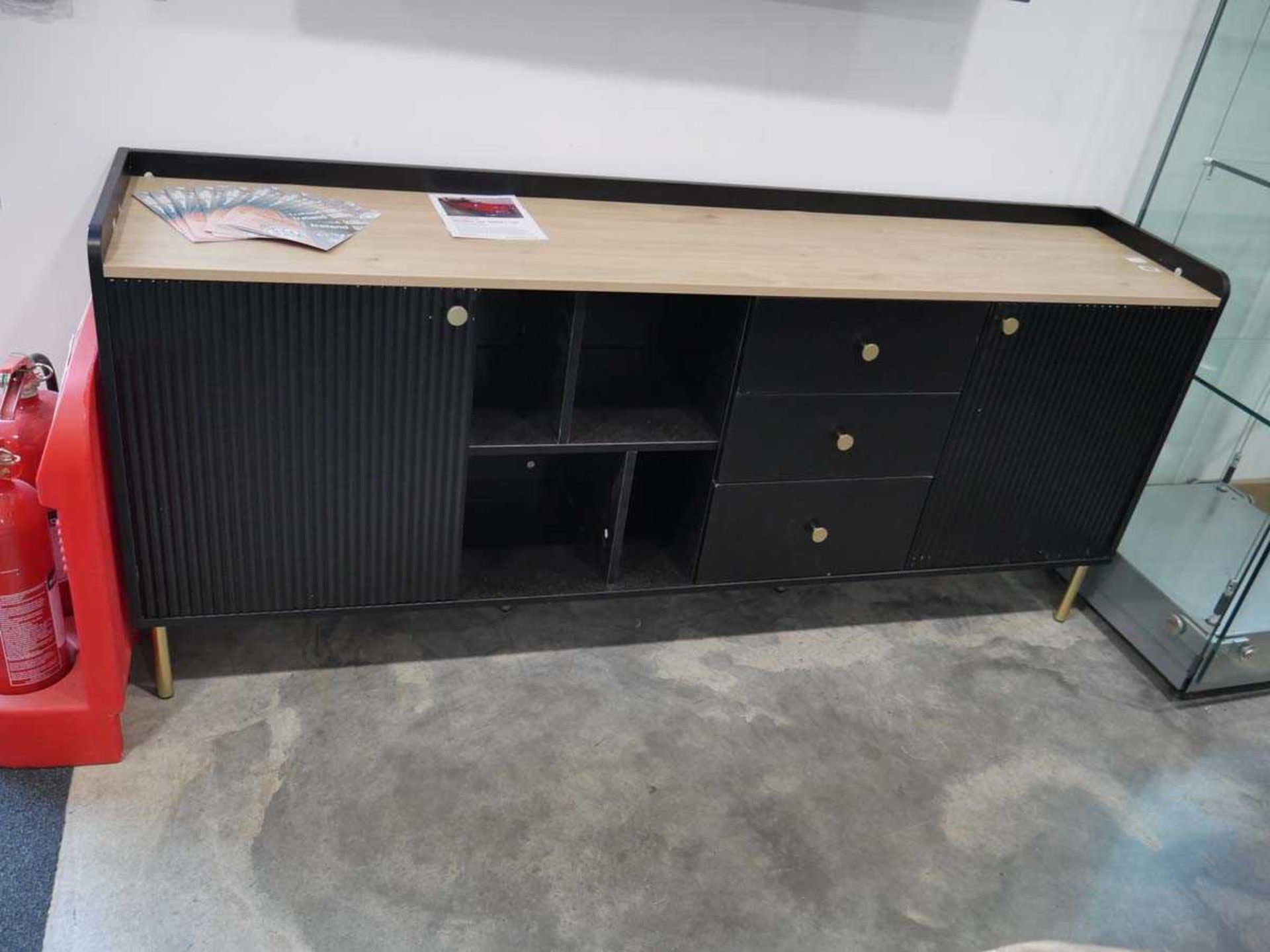 Long black and light wood wall unit with 2 cupboards, 3 drawers and open shelving space