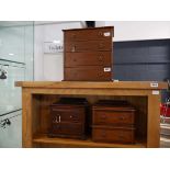 2 small wooden drawer units together with a wooden desk top chest