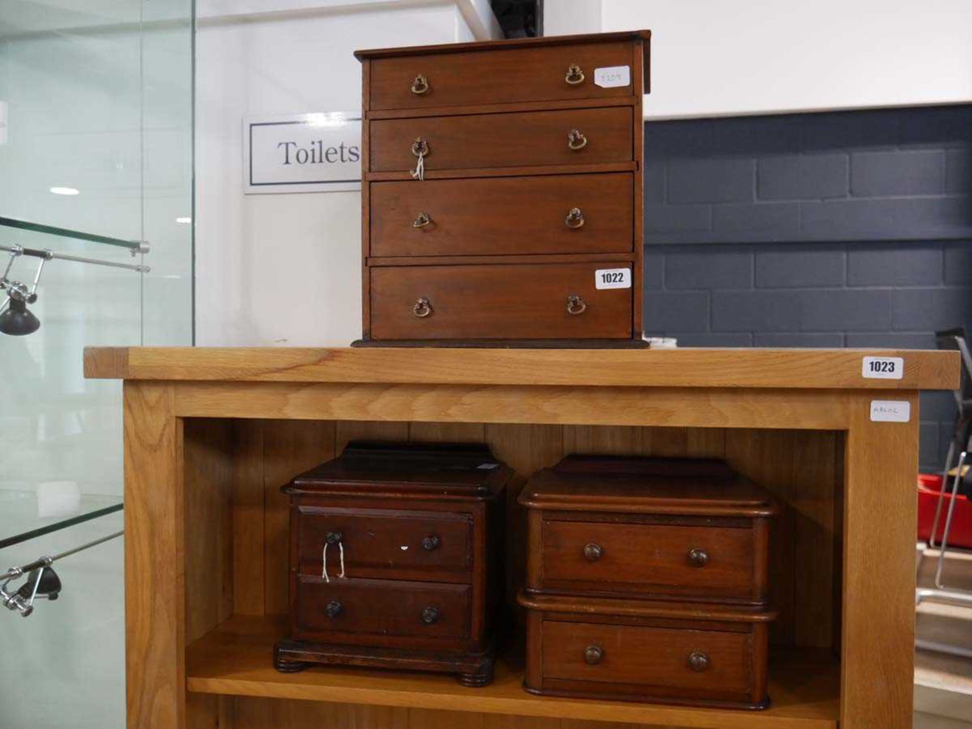 2 small wooden drawer units together with a wooden desk top chest