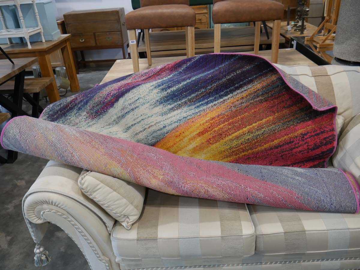 Large multi coloured rug in mainly blue and pink