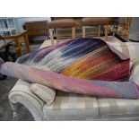 Large multi coloured rug in mainly blue and pink