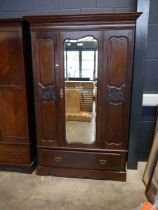 Edwardian mahogany wardrobe with bevelled mirrored central door and single drawer to base