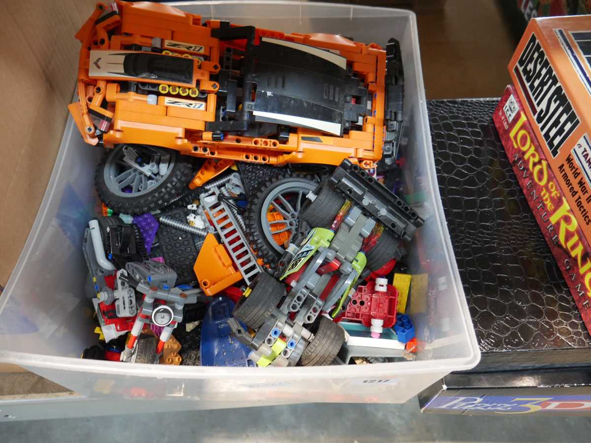 Box containing various Lego cars, motorbikes and other pieces