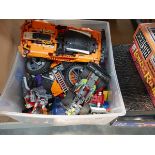 Box containing various Lego cars, motorbikes and other pieces