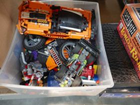 Box containing various Lego cars, motorbikes and other pieces