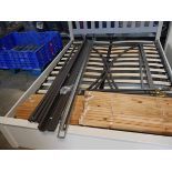 Unassembled metal double bed frame with wooden slats