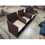 4 brown rattan garden armchairs each with beige coloured cushions